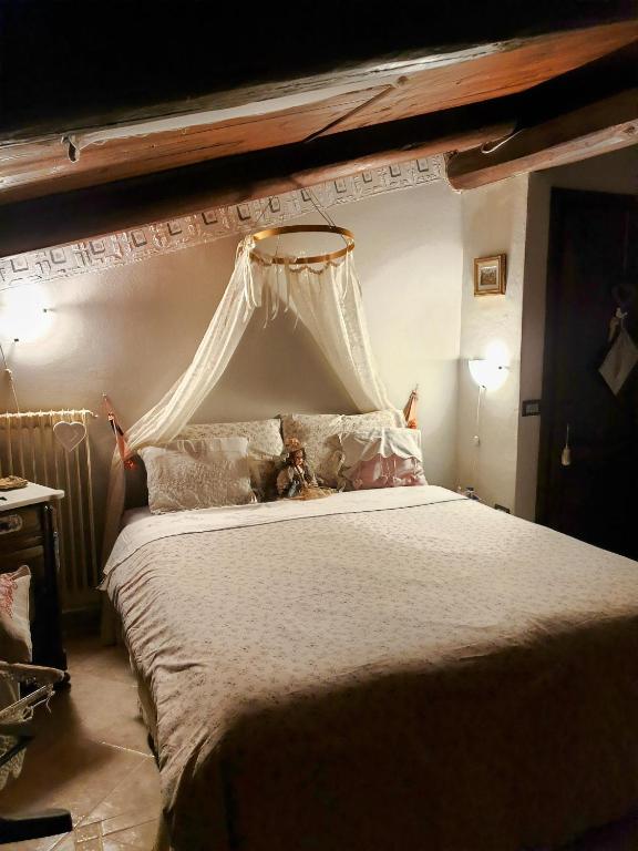 a bedroom with a large bed with a canopy at Creativ hause in San Giuliano Terme