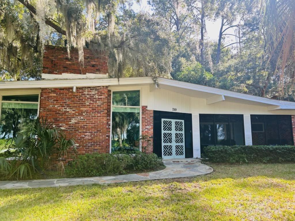 a red brick house with a black door at Meet Me At Sunset in Jekyll Island