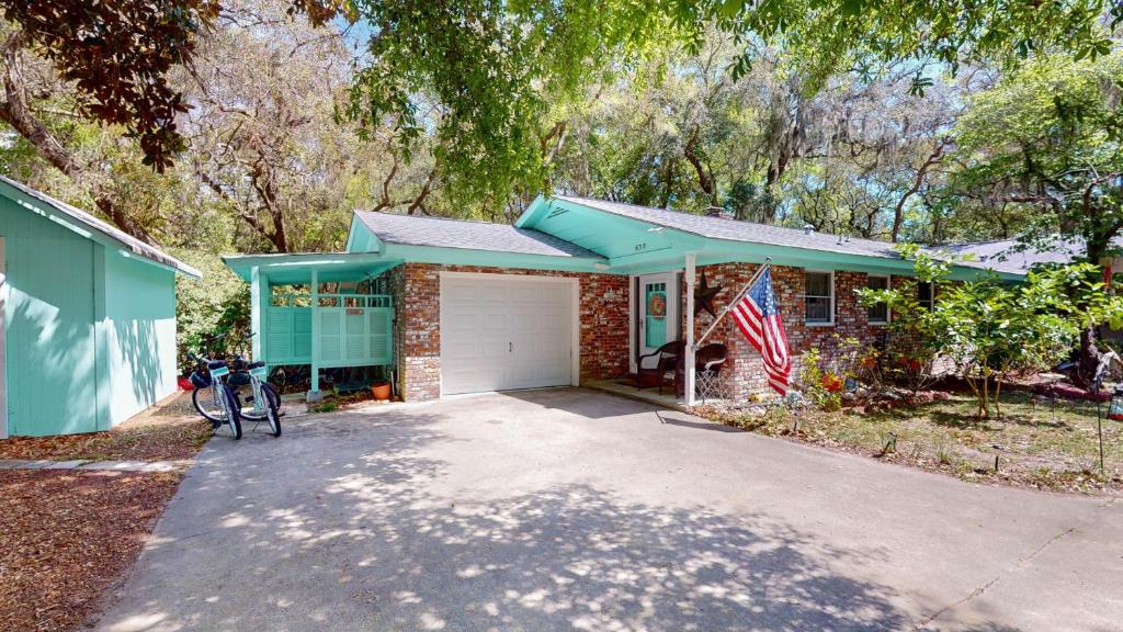 een stenen huis met een vlag ervoor bij A Hidde Gem Duplex in Jekyll Island