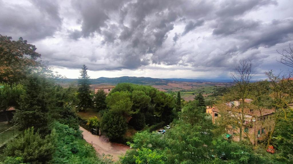 an overhead view of a building and trees under a cloudy sky at Ciliano 16 in Montepulciano