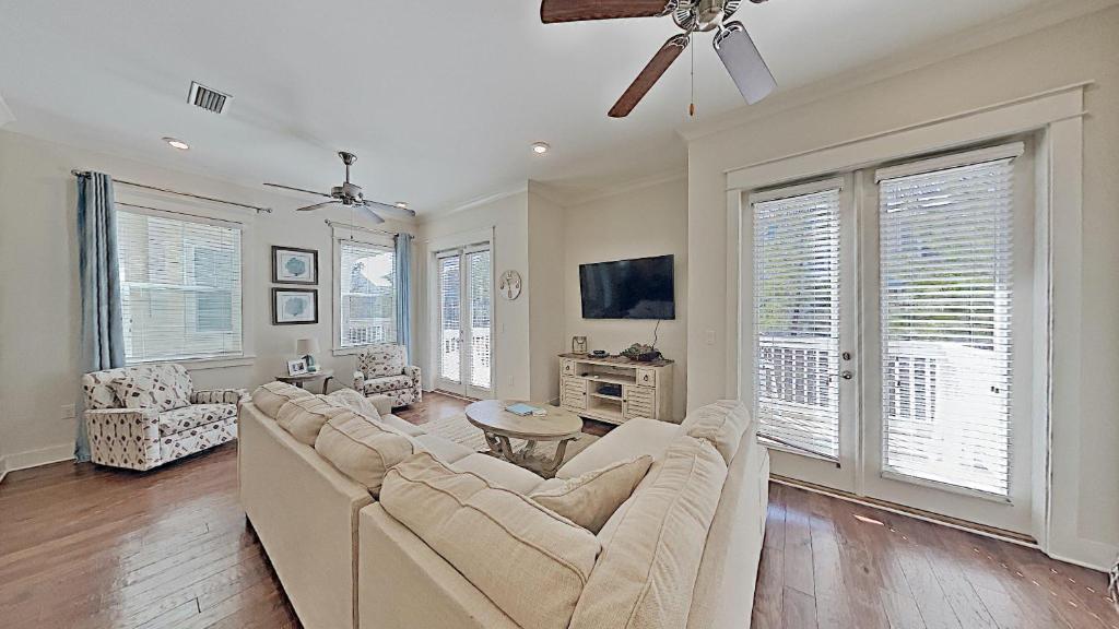 a living room with a couch and a ceiling fan at Prominence 30A - Mint Julep in Inlet Beach