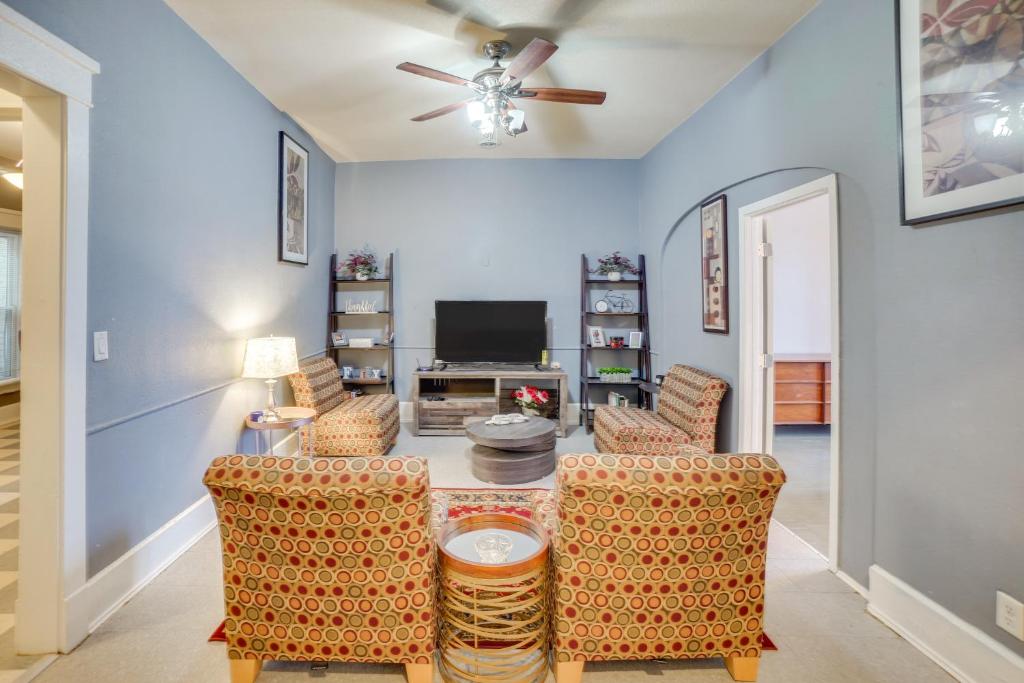a living room with chairs and a ceiling fan at 1 Mi to Lake Michigan! Urban Racine Apartment in Racine