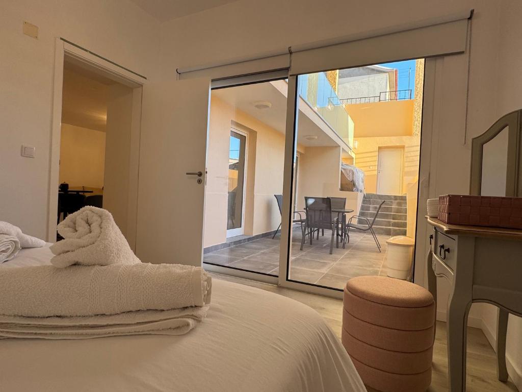 een slaapkamer met een bed en uitzicht op een balkon bij Charming Seaside Flat in Paul do Mar