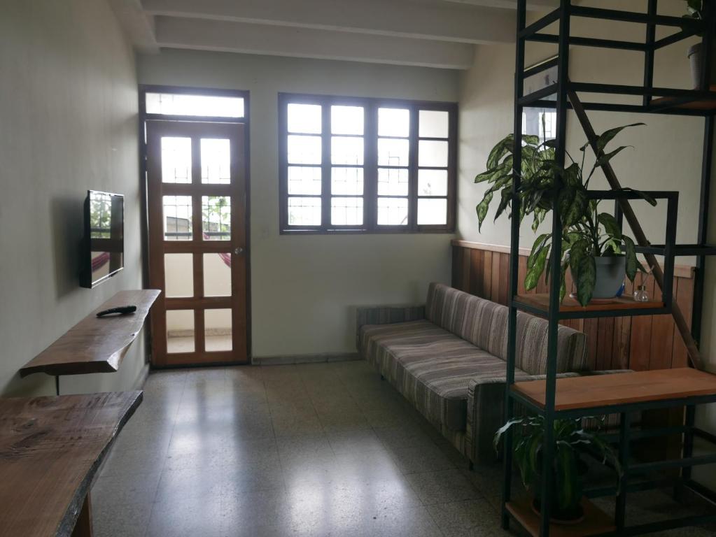 a living room with a couch and some windows at Apart-hotel alessia in Santiago