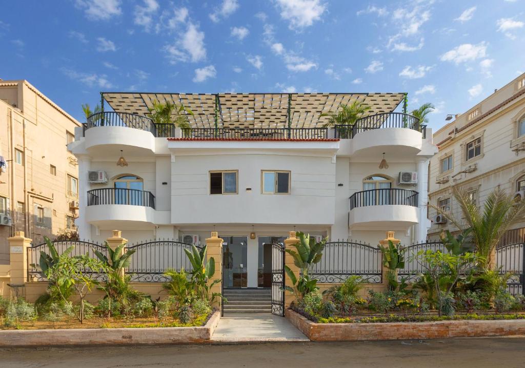 a white building with a balcony on top of it at Seven Stays New Cairo in Cairo