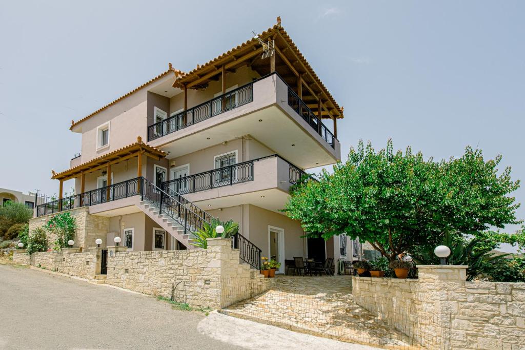 a large house with a stone retaining wall at Creta Sea View 2BR Maisonette by ΜΡS in Marathokefála