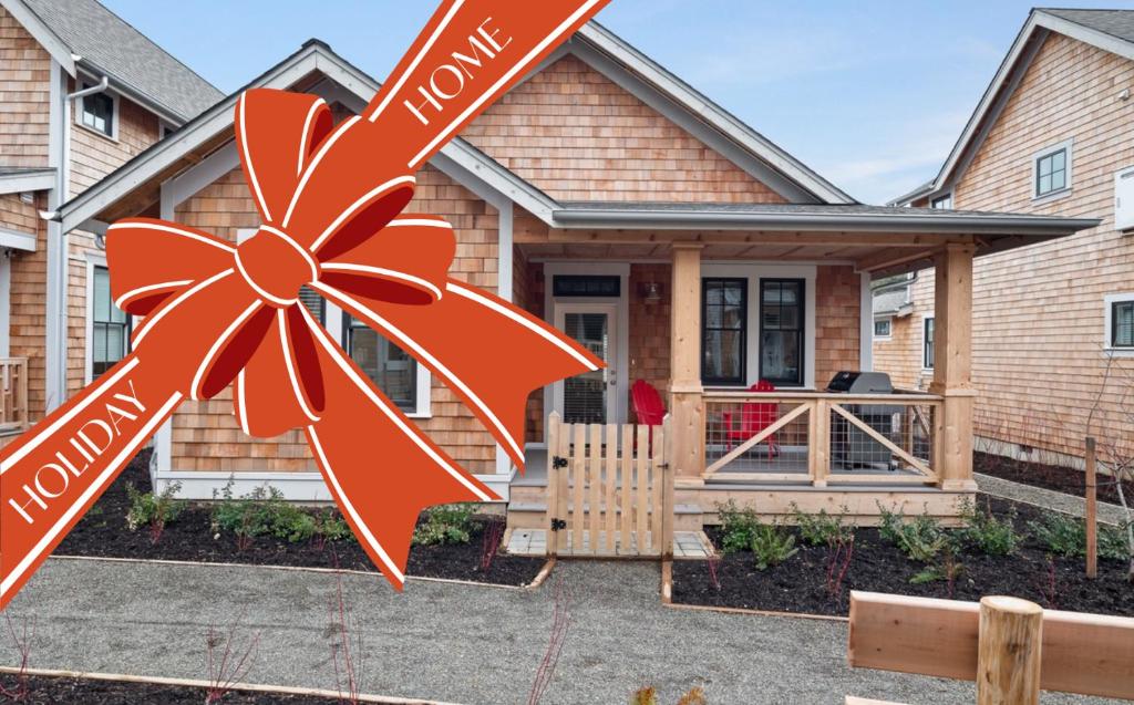 a house with a large orange bow in front of it at Salt and Vine Cottage by Seabrook Hospitality in Pacific Beach