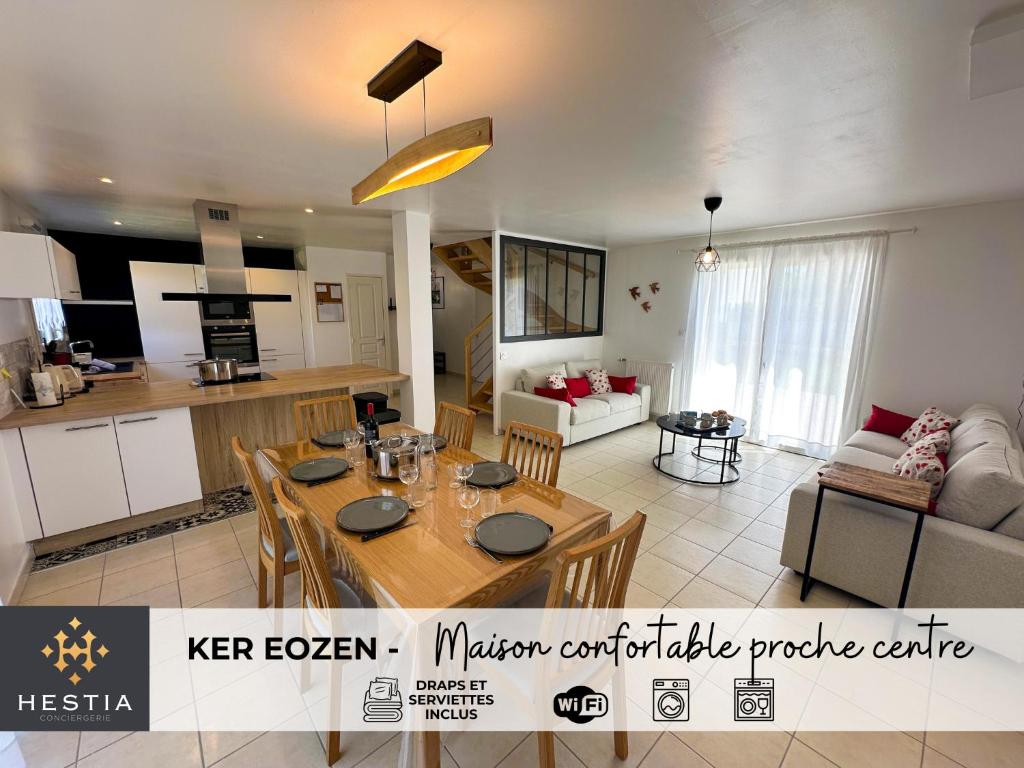 a kitchen and a living room with a dining table at KER EOZEN - Maison confortable en plein centre in Plouguerneau