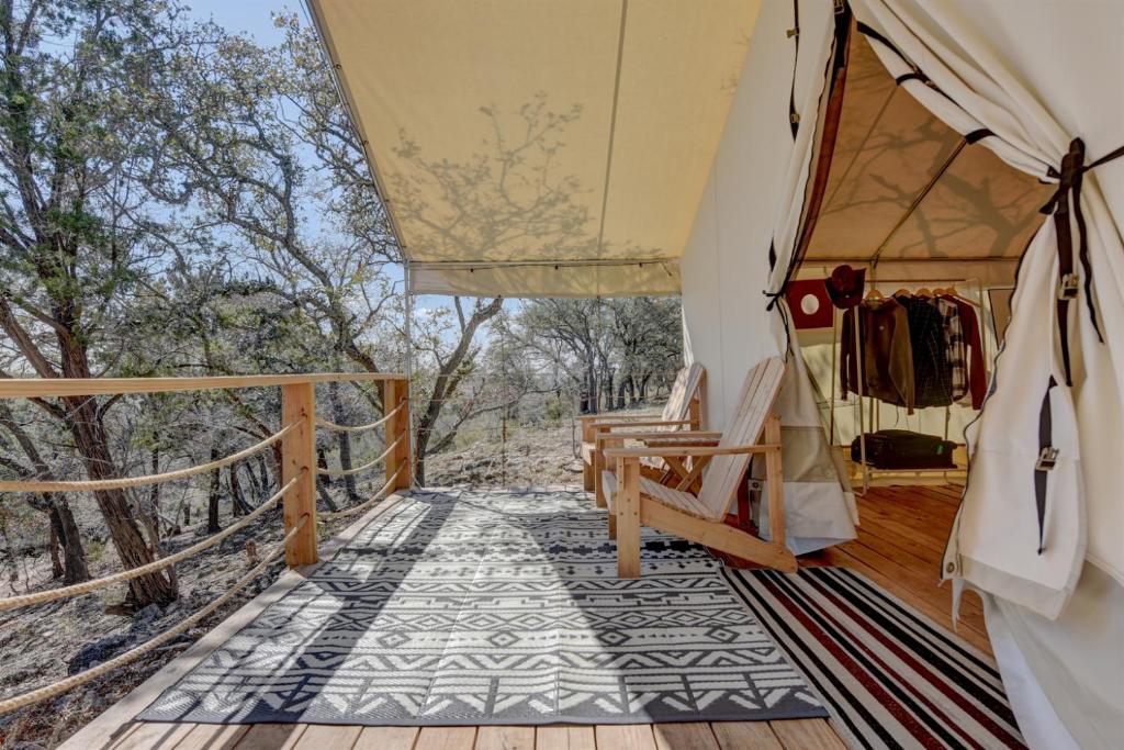 a view from the inside of a safari tent with a deck at Hill Country Escape Glamping Tent in Boerne