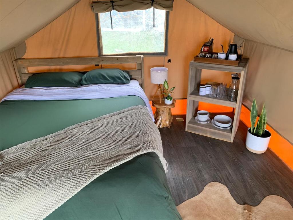 a bedroom with a bed in a tent at Cozy Glamping Minutes from SpaceX Launches in Colonia Acres