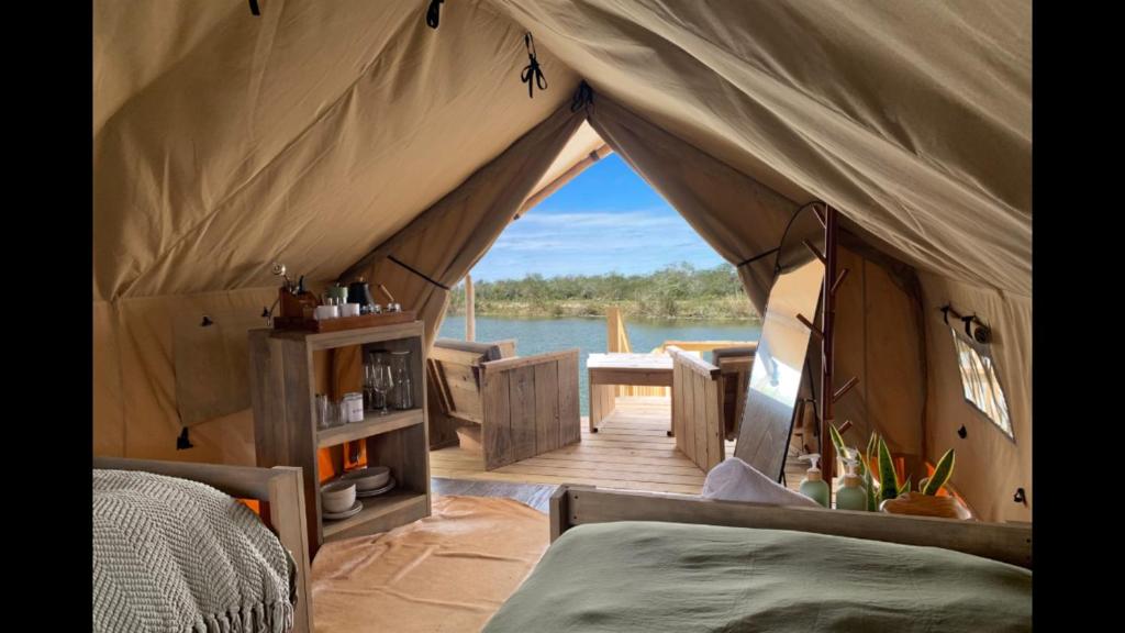 a luxury tent with a view of the water at Boutique Safari Tent Near SpaceX Launch Site in Colonia Acres