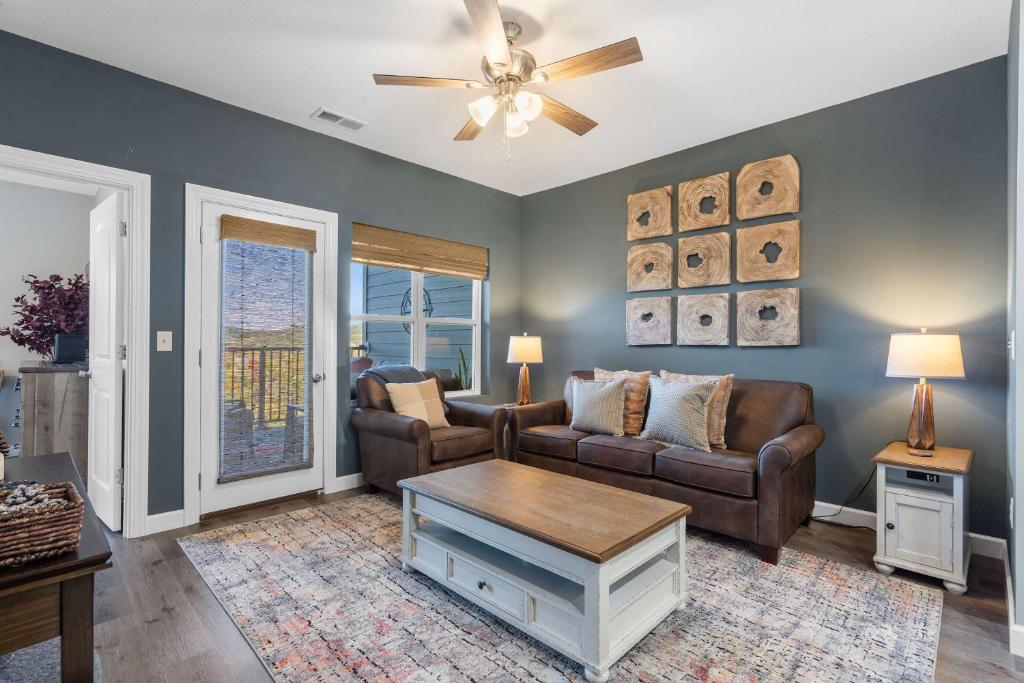 a living room with two couches and a ceiling fan at Crossroads Vistas - 3BDR Condo in Branson