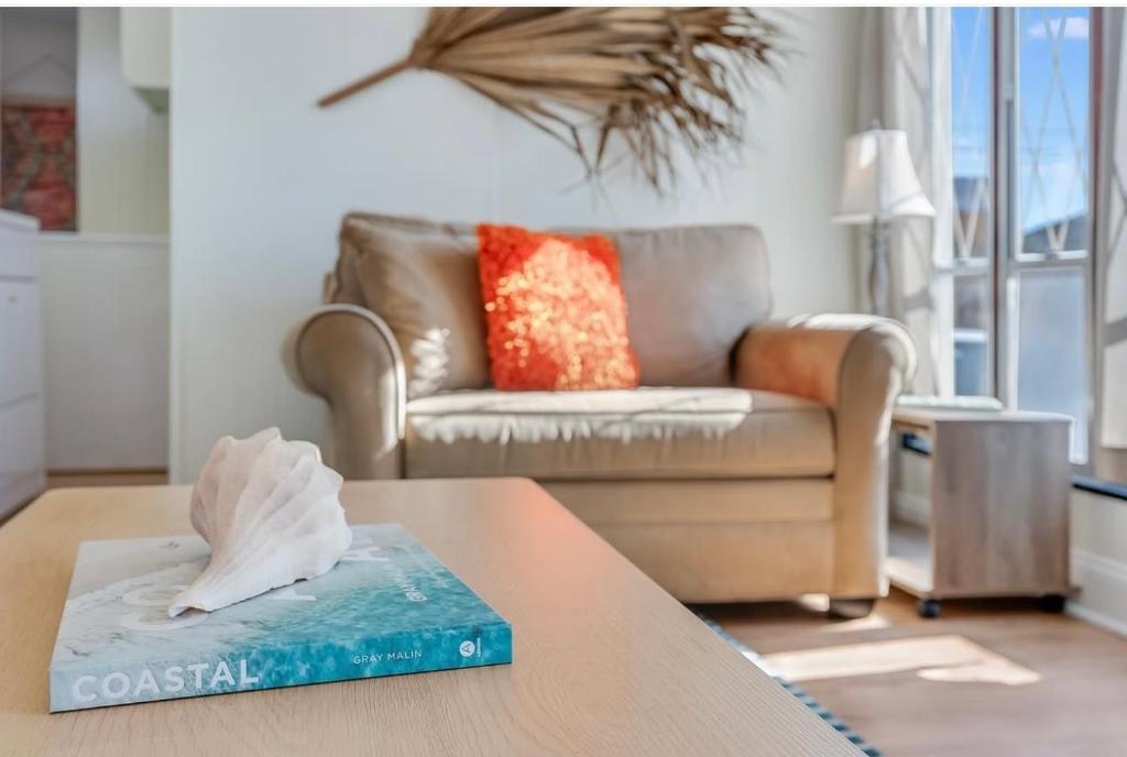 a living room with a couch and a table at The Cozy Jamozy in Panama City Beach