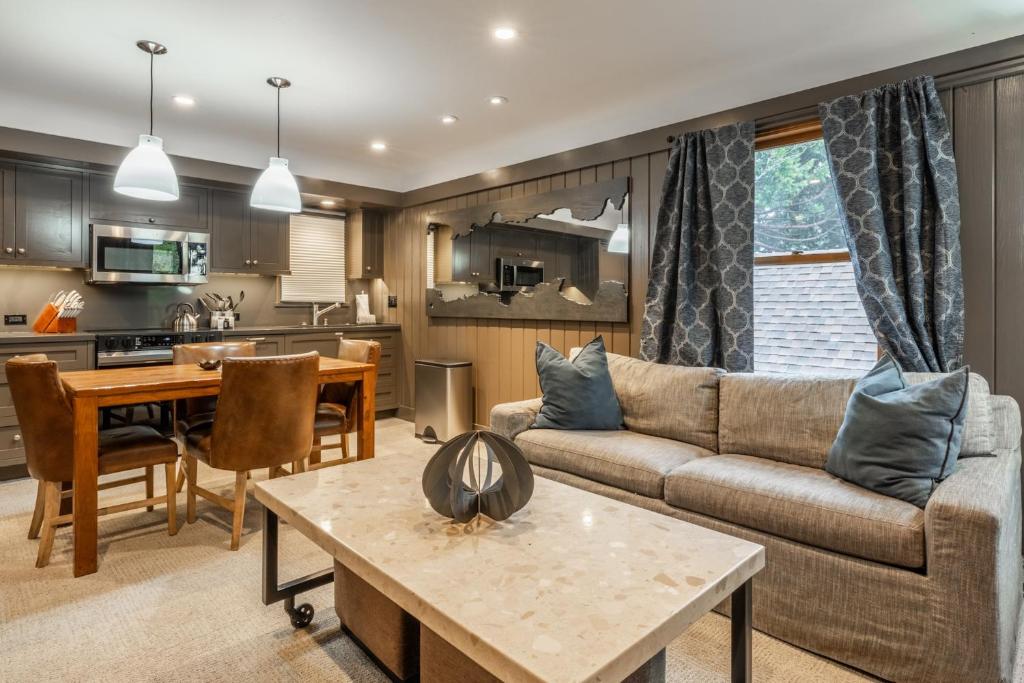 ein Wohnzimmer mit Sofa und Tisch in der Unterkunft Cedar Crest - Osprey Cottage 3 in Homewood