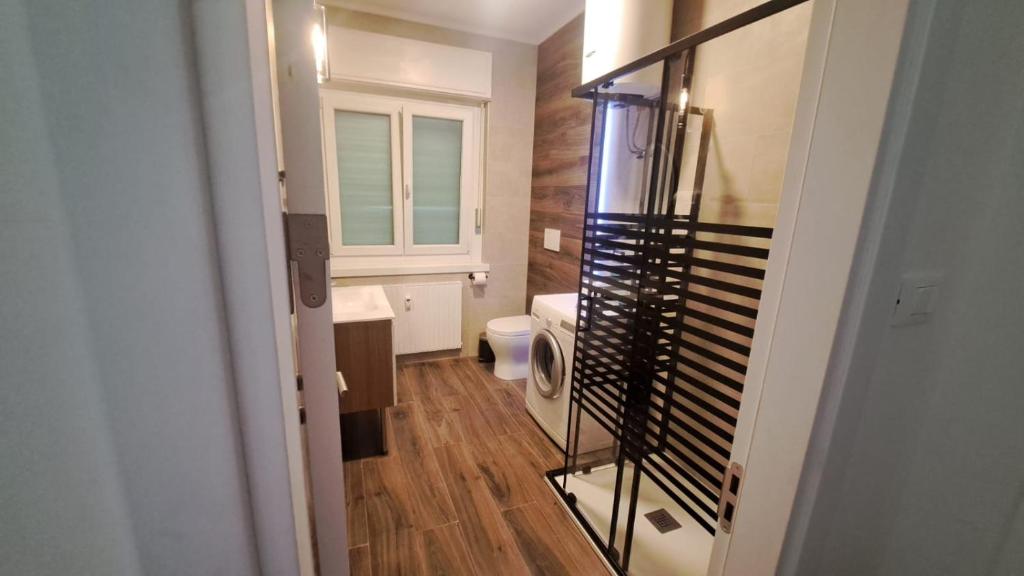 a small bathroom with a toilet and a window at Harmony in Trieste