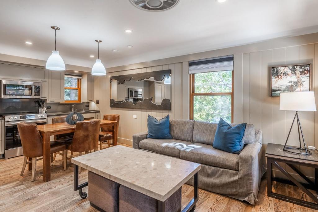 ein Wohnzimmer mit Sofa und Tisch in der Unterkunft Cedar Crest - Sparrow Cottage 1 in Homewood