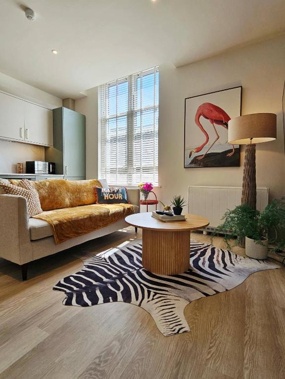 a living room with a couch and a table at Apartment Ten Pelican House in Bournemouth