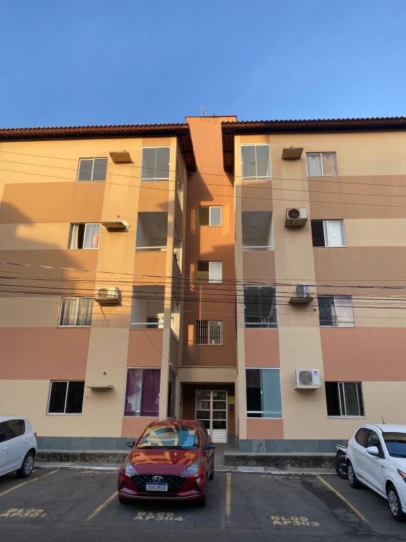a car parked in a parking lot in front of a building at Apartamento Solaris in São Luís