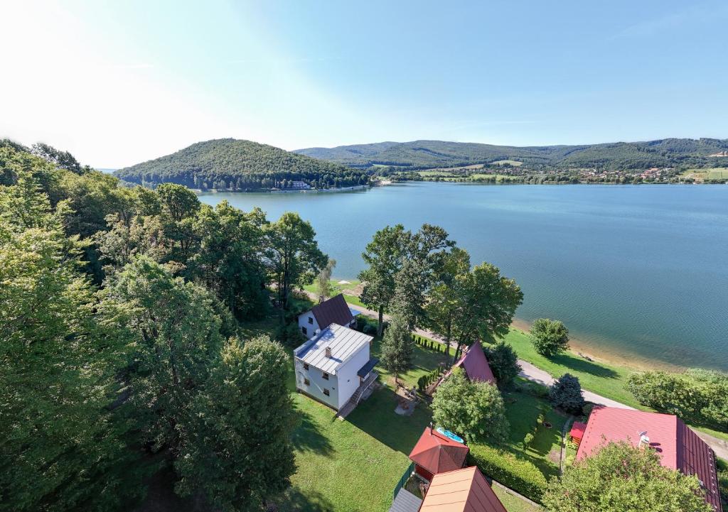 an aerial view of a house on the shore of a lake at VILLA Ružiná in Divín