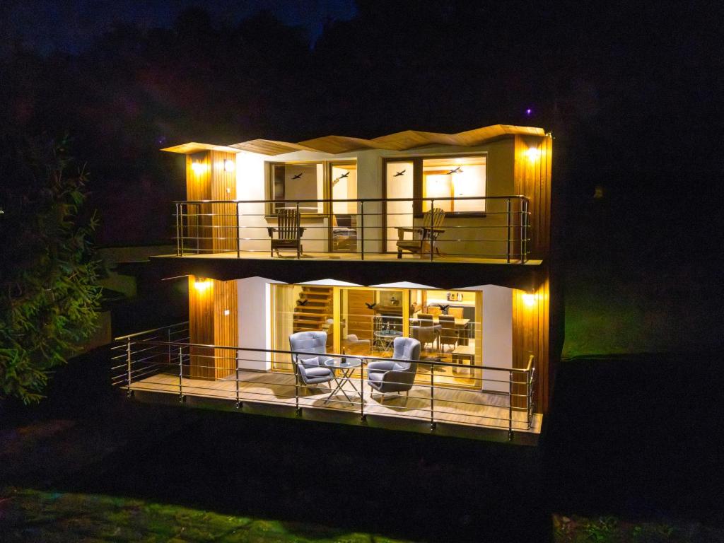 a house with two chairs on a deck at night at VILLA Ružiná in Divín