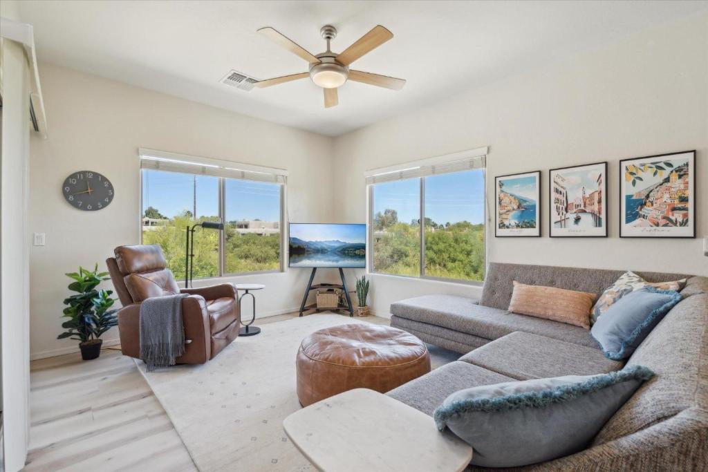 a living room with a couch and a ceiling fan at Panorama View - Mountain Views - Community Pool in Fountain Hills