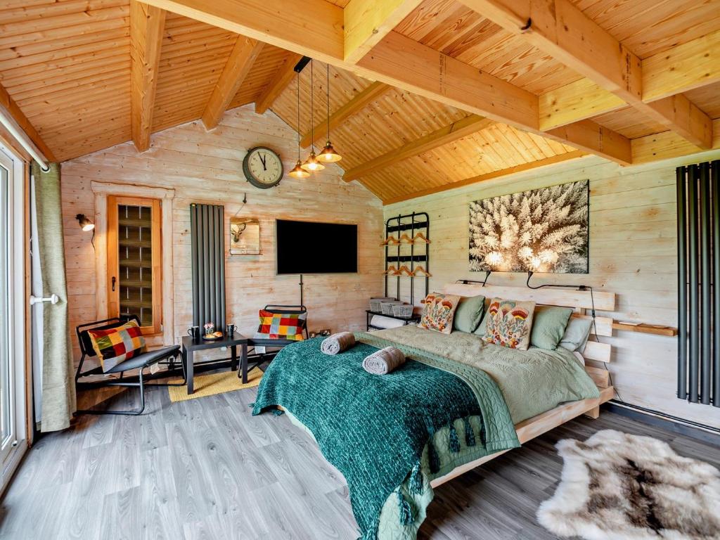 a bedroom with a bed and a tv in a room at 1 Bed in Dearham 96373 in Dearham