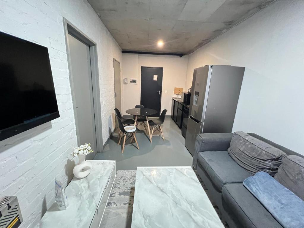 a living room with a couch and a table at The eland in Johannesburg