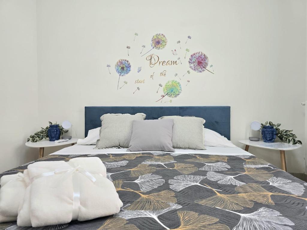 a bedroom with a bed with a flower clock on the wall at CJ SEA HOME CAMERE in Trapani