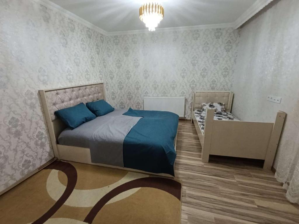 a bedroom with a bed and a crib in it at Nakhchivan Family Home in Naxçıvan