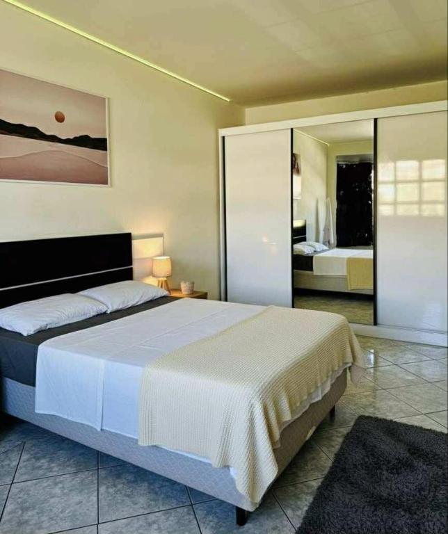 a bedroom with a large bed in a room at Hostel Londrina in Londrina