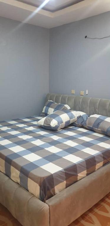 a large bed sitting in a room with at ED Apartment in Mama