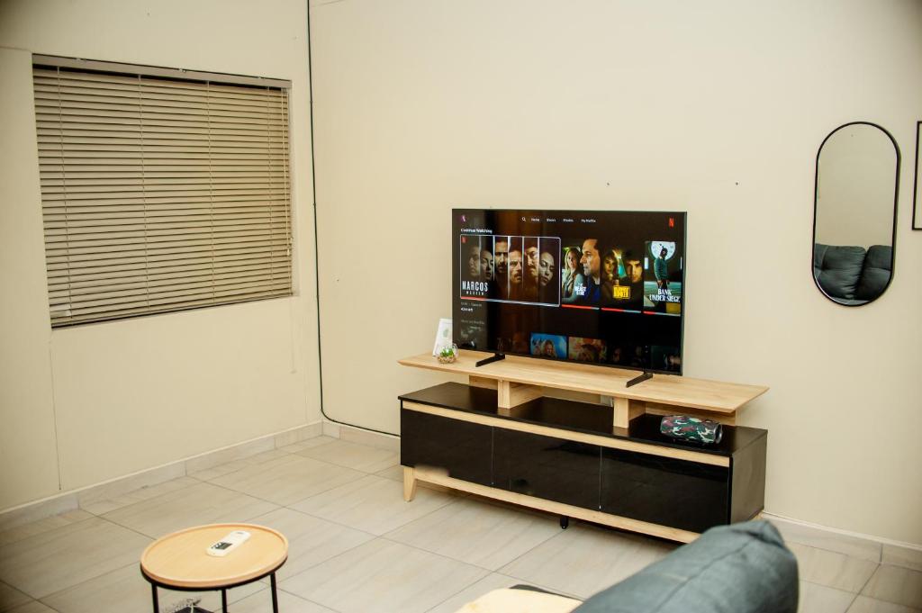 a living room with a tv and a couch at Villa Ndahafa in Ongwediva