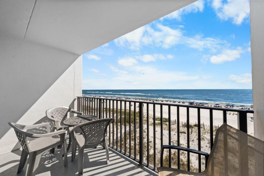a balcony with a table and chairs and the ocean at Island Sunrise 362 by Youngs Suncoast in Gulf Shores