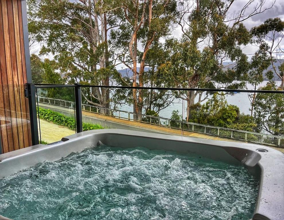 a hot tub on the balcony of a house at Bay View Retreats- Ocean mist in Dover