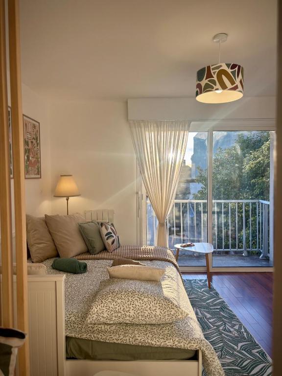 塔朗斯Terra Verde I Cozy Studio WIFI I Balcon & Parking的一间卧室，里面有一张床和一扇大窗户。