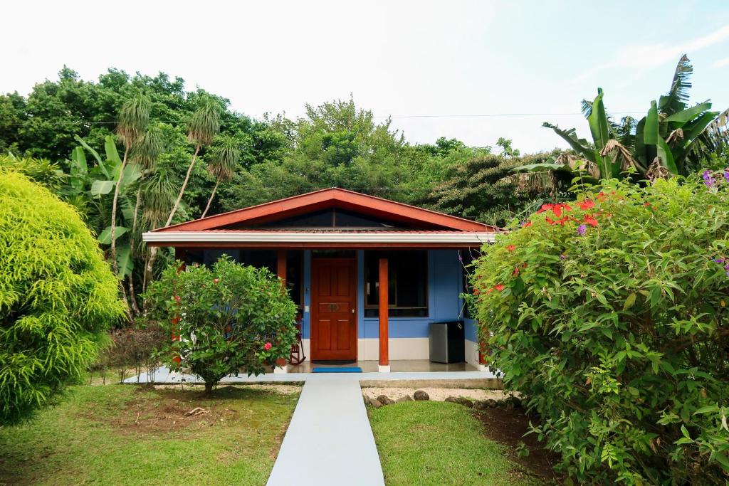 a small blue house with a red roof at Sueño Río Celeste Boutique B&B in Bijagua