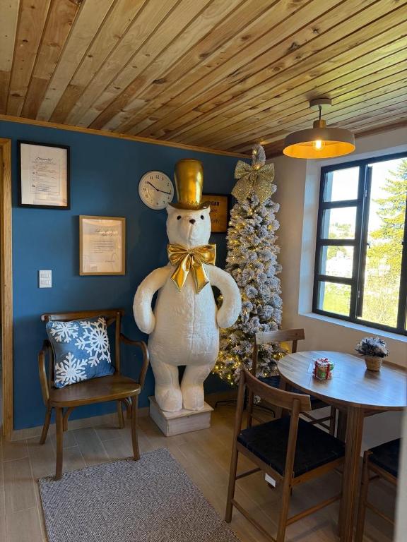 a room with a christmas tree and a statue of a bear at El Sótano Loft in Tlalpujahua de Rayón