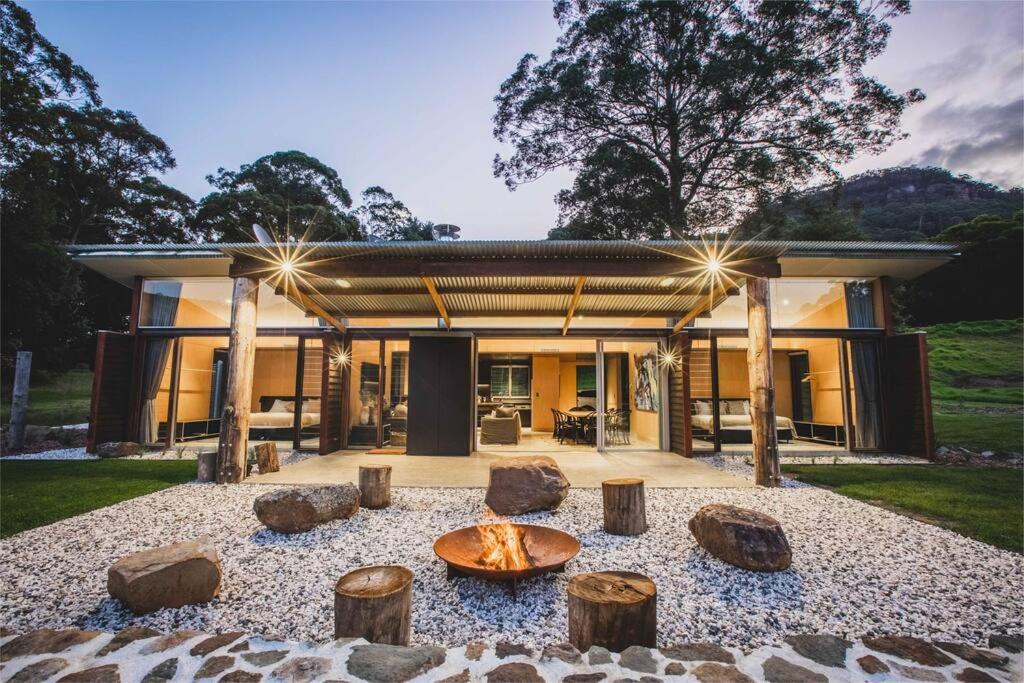 a house with a fire pit in front of it at Willow at Barranca - Luxury Villa in Barrengarry