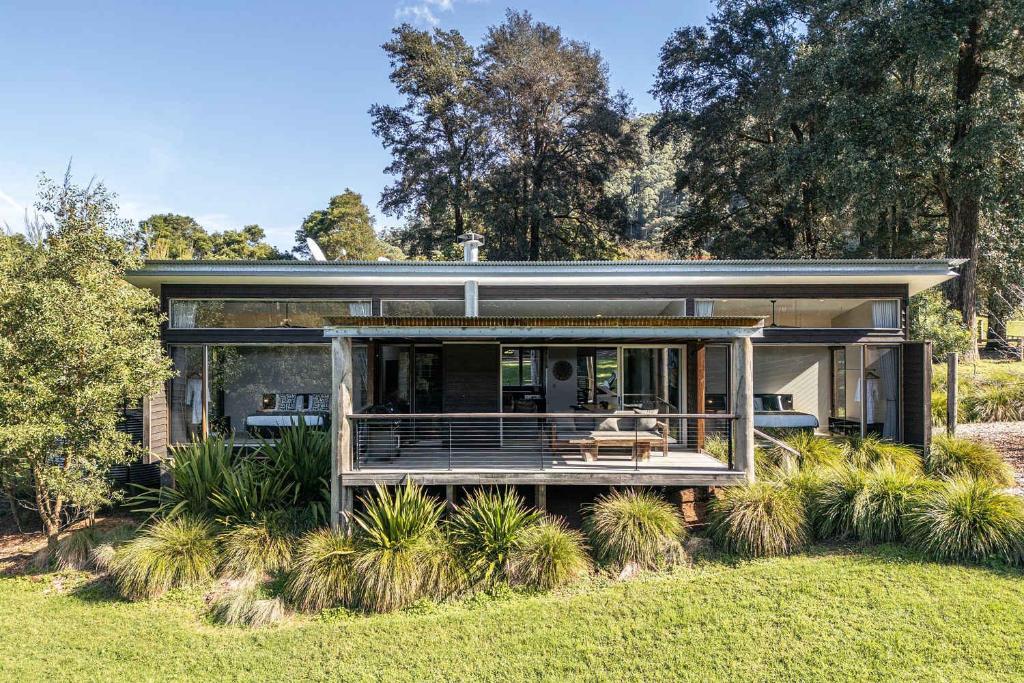 a house with a wrap around porch on a lawn at Ferndale at Barranca - Luxury Villa in Barrengarry