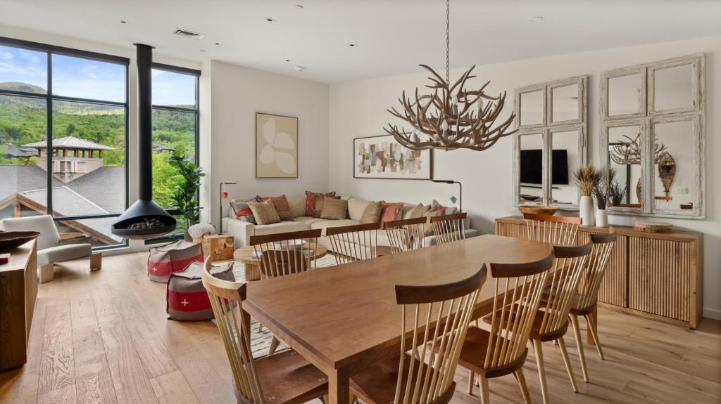 une salle à manger et un salon avec une table et des chaises dans l'établissement 420 Lodge At Spruce Peak New Treehouse Unit 3 bed Sleeps 10, à Stowe