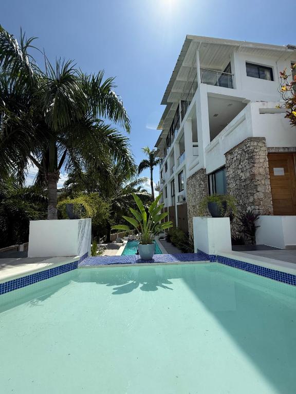 a swimming pool in front of a building at Kainos Tropical Boutique Hotel in Las Terrenas