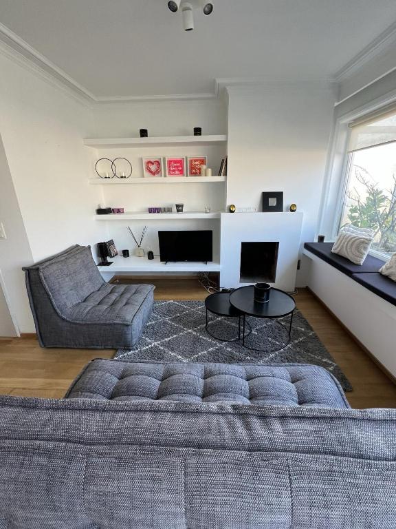 a living room with a couch and a table at Amazing penthouse in Zoutelaan in Knokke-Heist