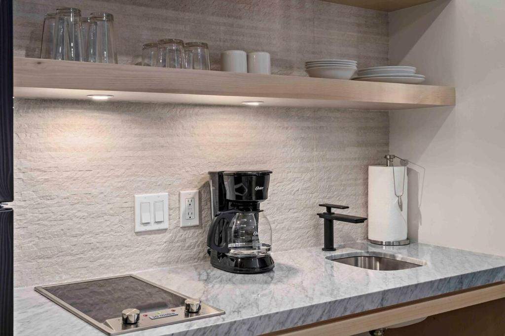 a kitchen counter with a coffee maker and a sink at Double Suite Luxury Retreat 605 Tower in Cabo San Lucas