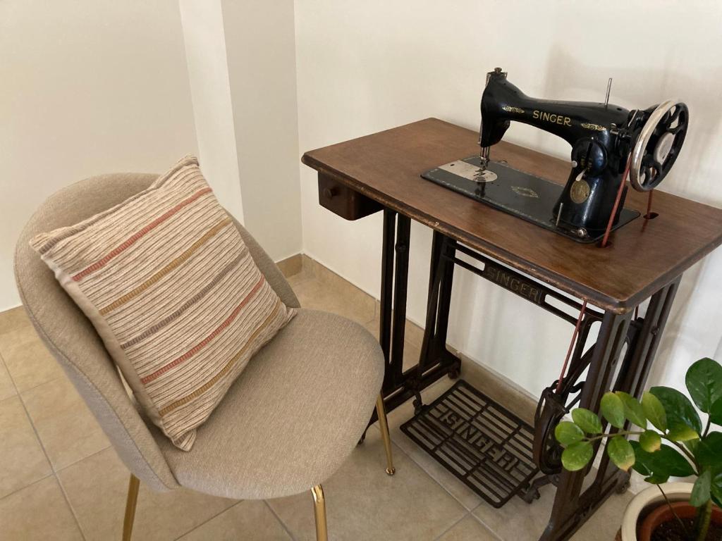 a sewing machine sitting on a table next to a chair at La Trita Dimore di Charme in Bussi sul Tirino