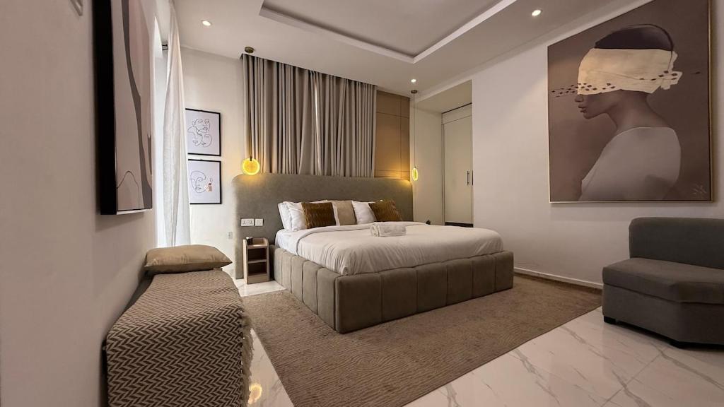 a bedroom with a bed and a chair and a couch at Rorex cozy cityview 1 bedroom apartment in Lekki