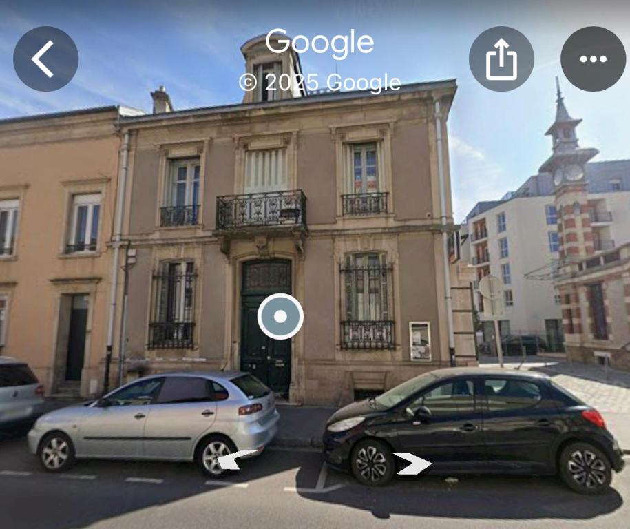 zwei Autos auf einem Parkplatz vor einem Gebäude geparkt in der Unterkunft Vasso 2 in Nancy
