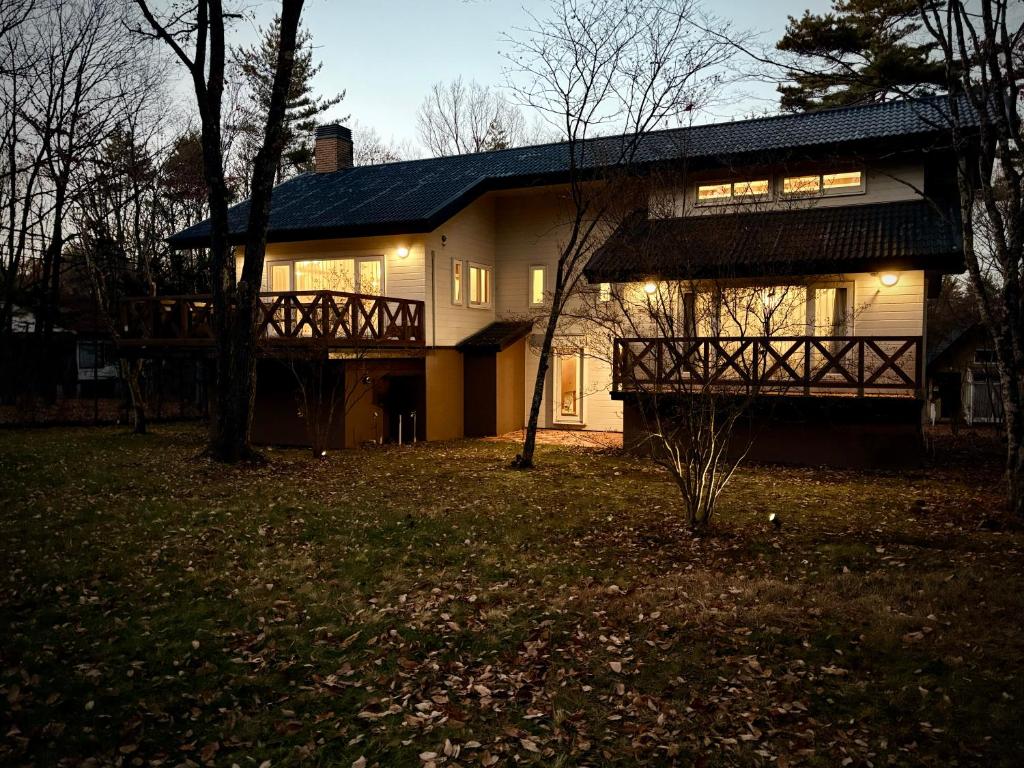 a large house with a porch and a balcony at Villa Lina - 北軽井沢で四季折々の自然を楽しむプライベート貸別荘 最大6名 in Naganohara
