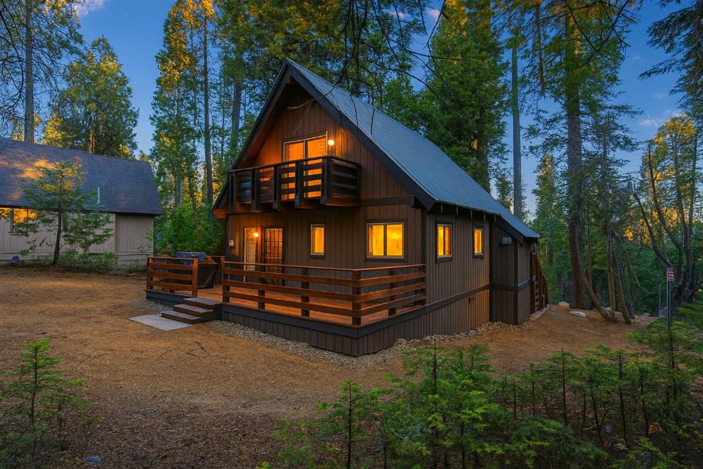 a large wooden cabin in the middle of a forest at Boss's Cabin - Boss-level views, zero stress! in Shaver Lake