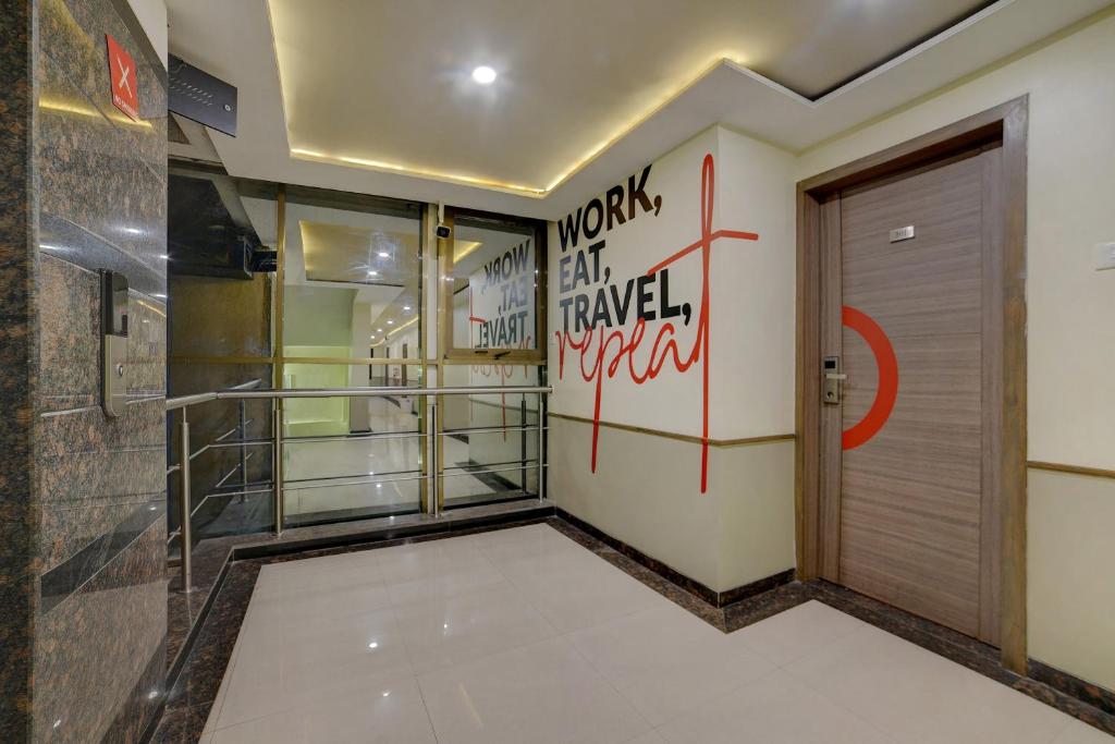 a hallway with a door and graffiti on the wall at Collection O Pune Railway Station Formerly Kapil Residency in Pune