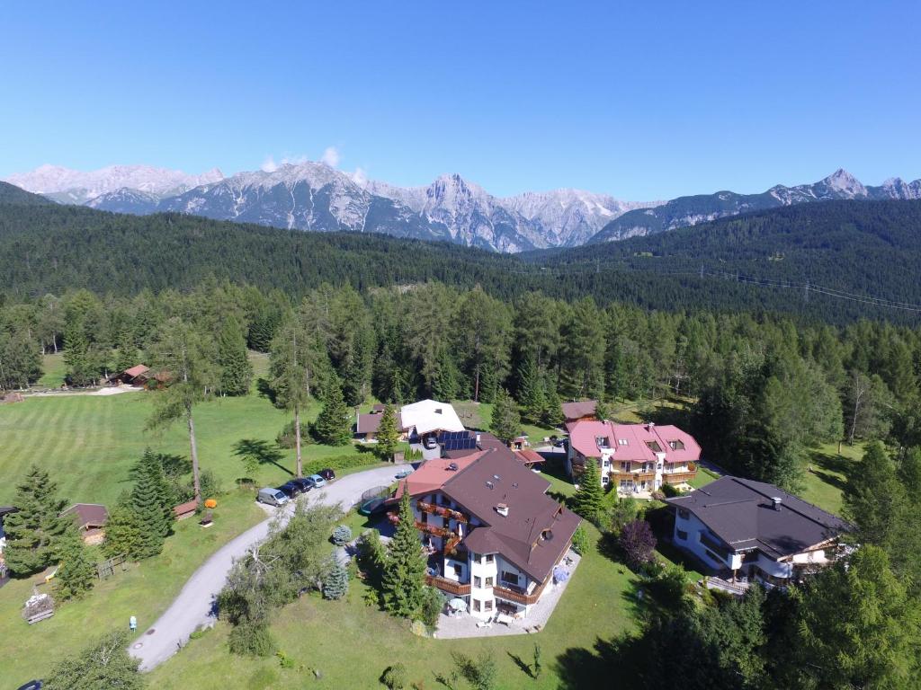 an aerial view of a large house in the mountains at Landhaus Charlotte Apartments Tirol in Seefeld in Tirol